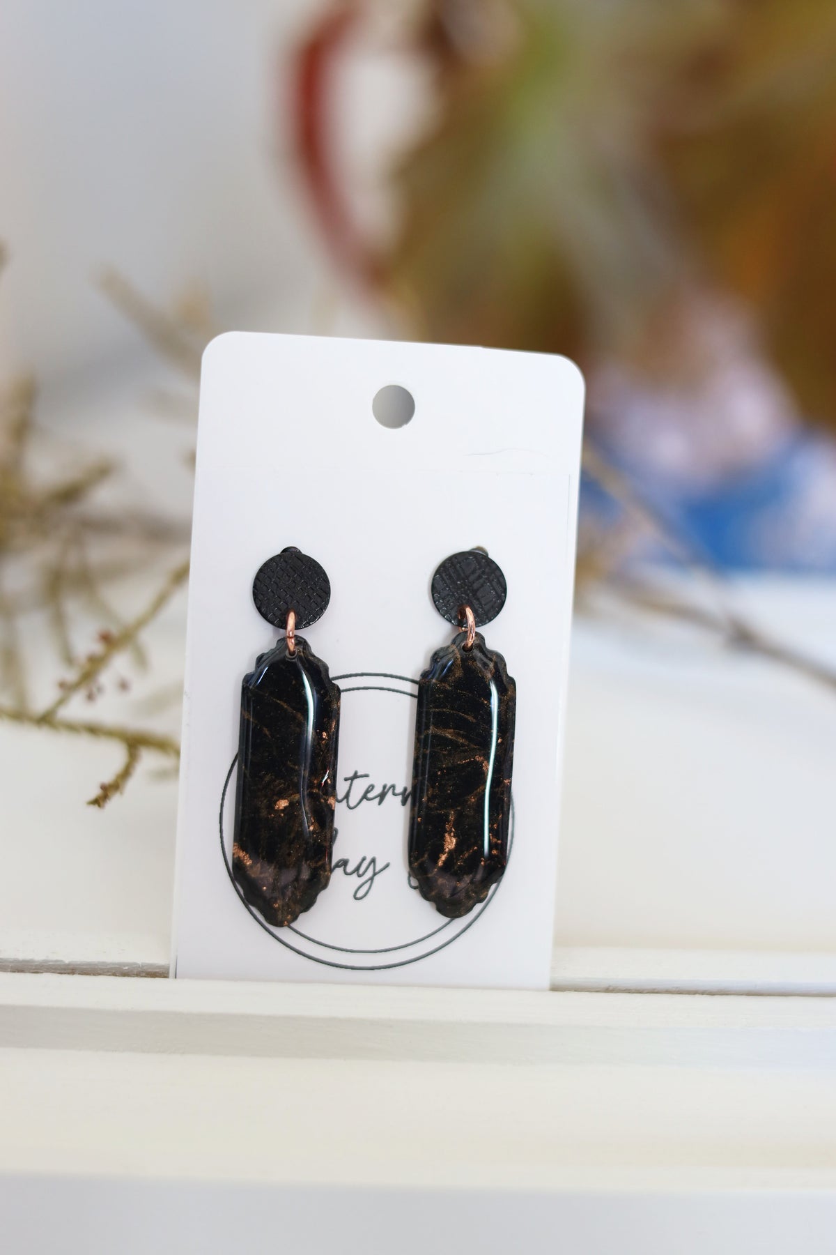 Black dangle earrings with rose gold foil