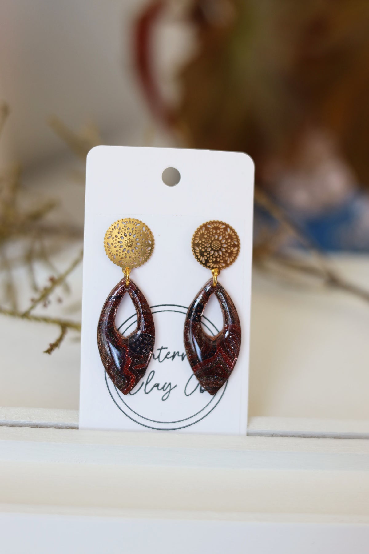 Faint Indigenous art decal on glittering rose gold clay