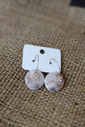 Abstract designed hoop earrings with rhinestone flower.