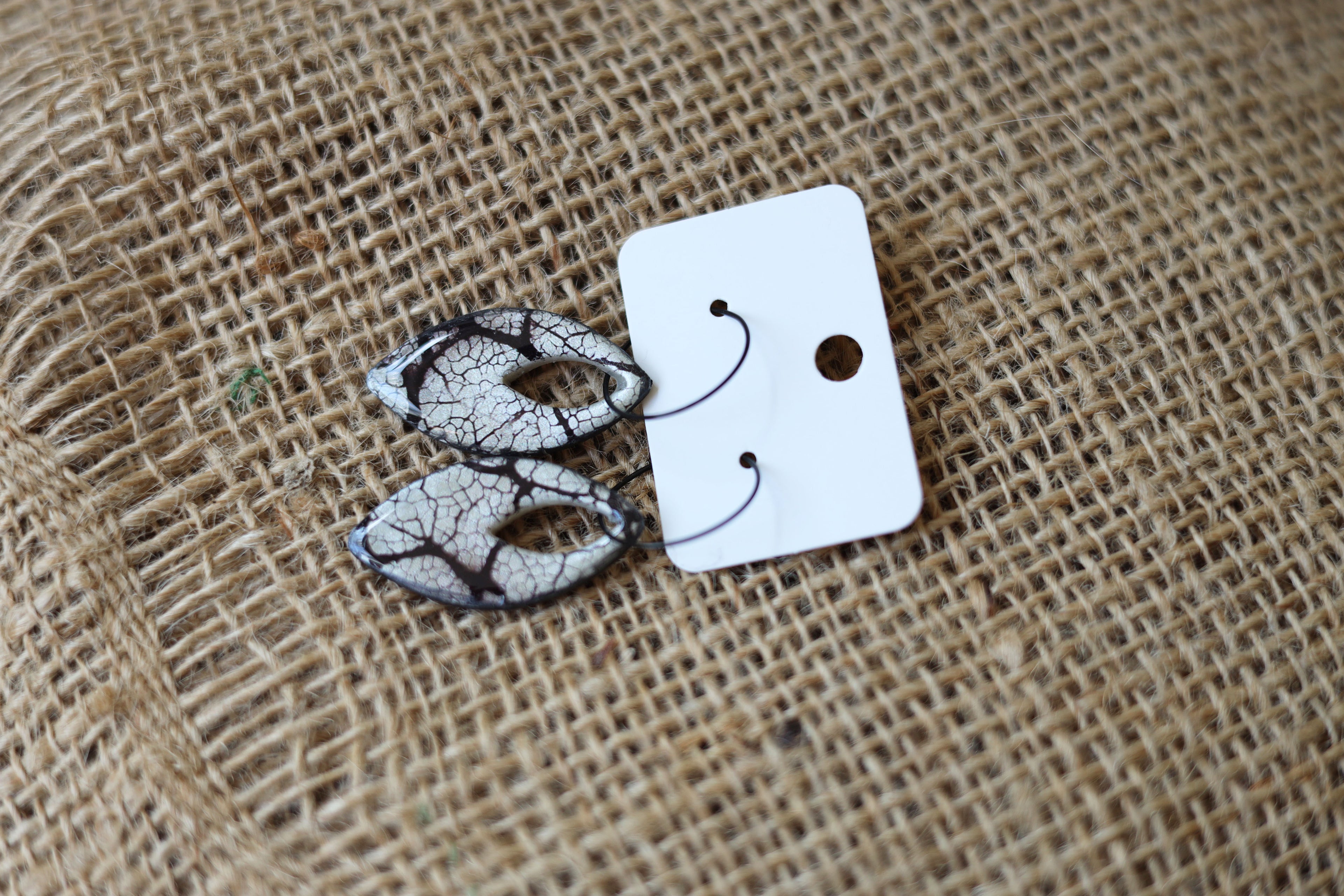 Black & pearl patterned dangle earrings