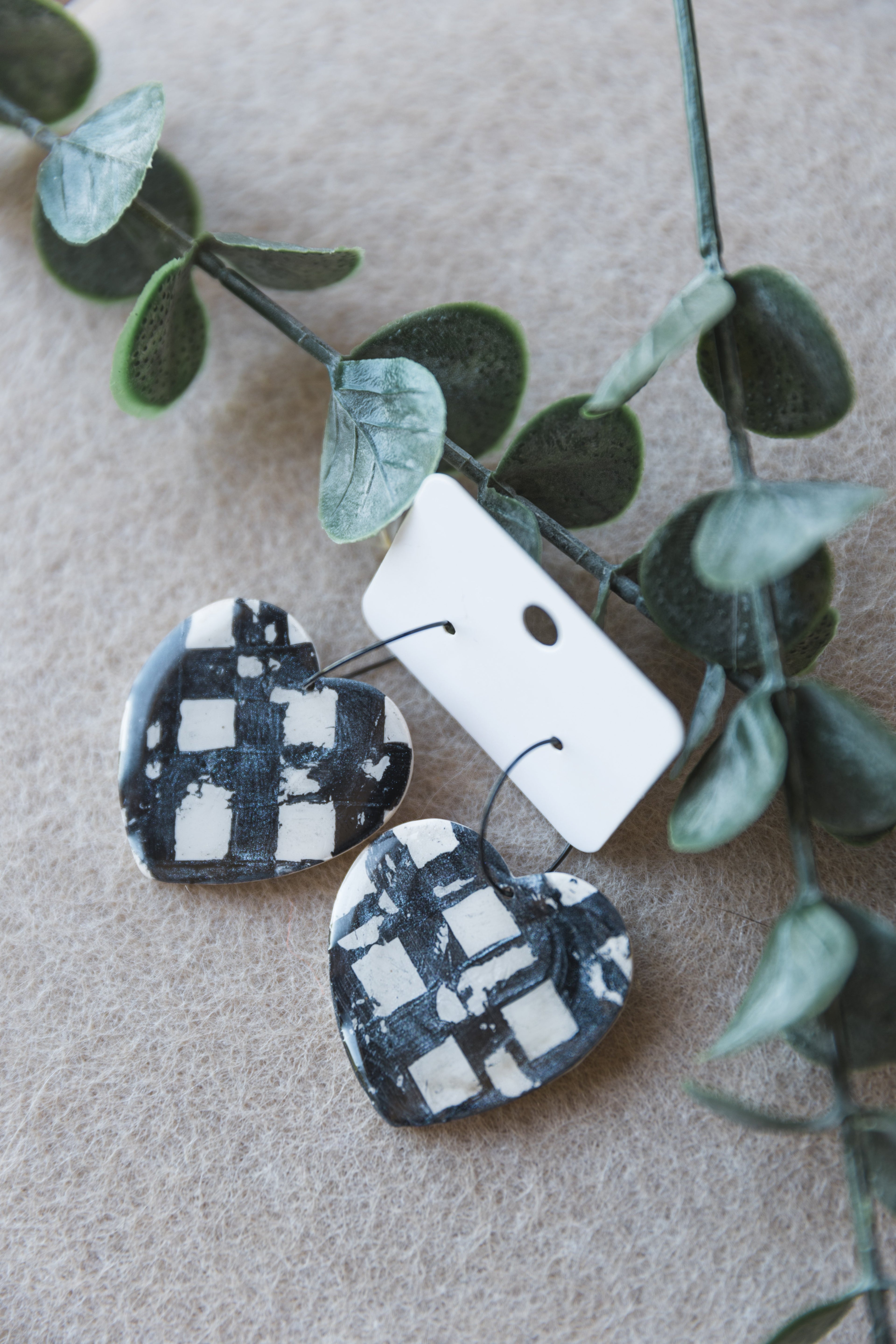 Painted black on white chequered big heart hoop earrings