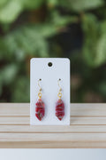 Magenta with specks of green faux stone dangle earrings