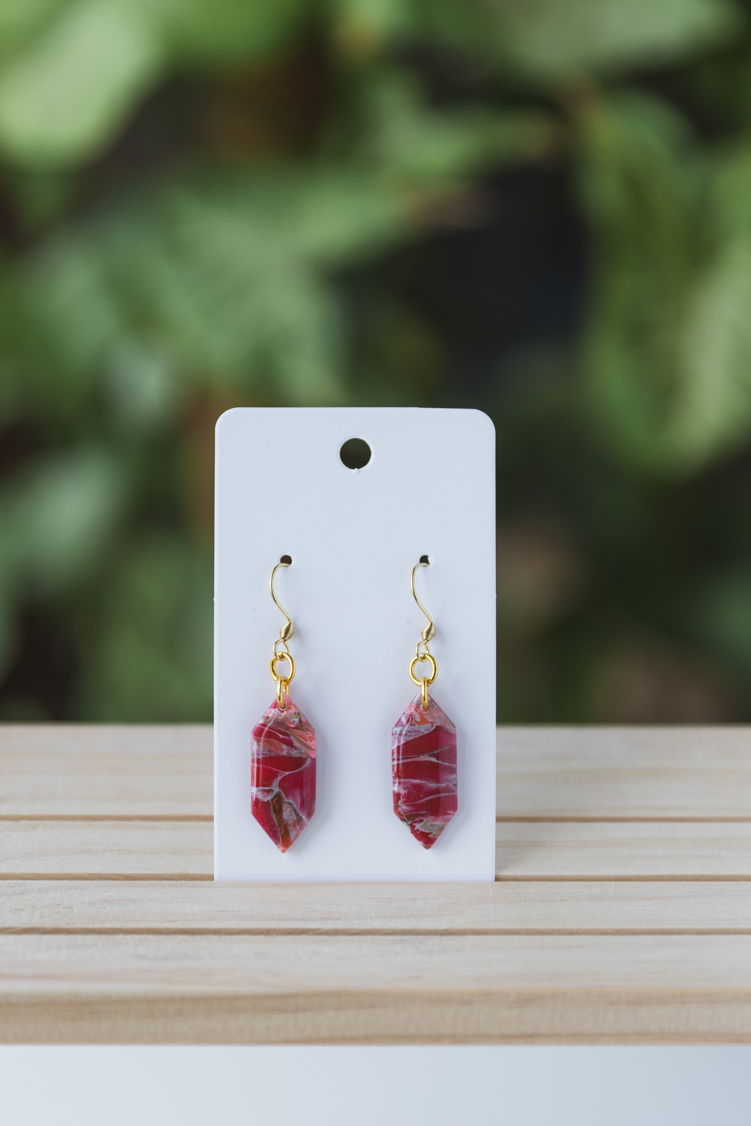 Magenta with specks of green faux stone dangle earrings